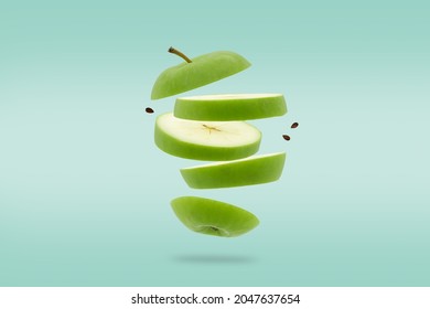 Stack Of Sliced Green Apple Flying Or Falling.Creative Levitation Food.
