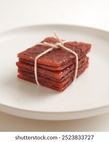 stack of sliced sheets of dried and crispy pork. Bak kwa isolated on white background