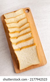 Stack Of Sliced White Bread On Cutting Board. White Background Texture. Flat Lay.