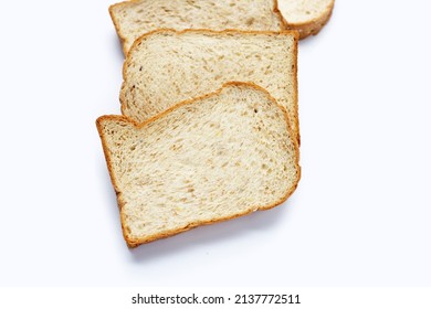 Stack of sliced wholegrain bread on white background.