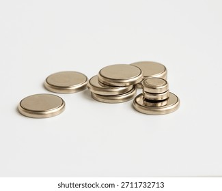 Stack of Small Lithium Coin Cell Button Batteries on White Surface