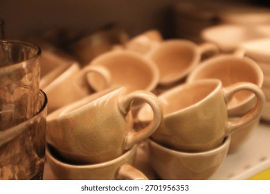 Stack of small minimalist aesthetic ceramic cups for coffee. Cafe, restaurant utensils. Stylish dusty pink coffee cups. Cute home decor, kitchen and dining room dishware. Home decor store merchandise.