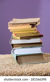 Stack of some old books piled on a table. 
