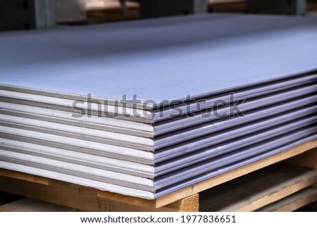 The stack of Special gypsum board with enhanced sound Acoustic insulation Plasterboard. Panel Type DF for indoor concrete walls prepared for construction
