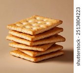 A stack of square crackers . The crackers have a crisp, slightly flaky texture with small perforations on the top surface. The surface of the crackers has a light sheen. they may be slightly buttered.