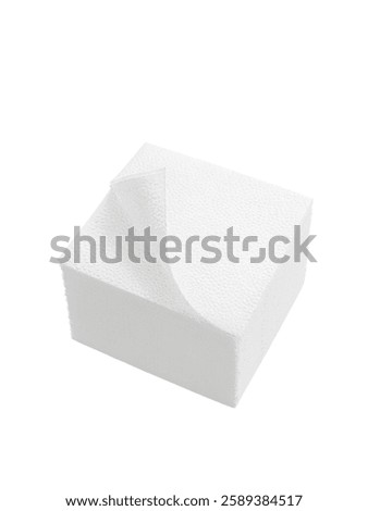 A stack of square paper napkins with a bent corner on a white background. Photo. View from above.