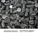 Stack of stainless steel rods in a container box.Steel bar cutting. The raw material for manufacturing by CNC milling machine.