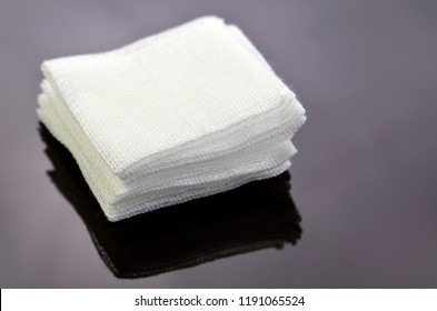 Stack Of Sterile Gauze Pad On Dark Background.