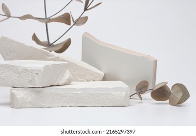 Stack stones platform podium and leaf twig on gray light copy spase background. Minimal empty display product presentation scene.