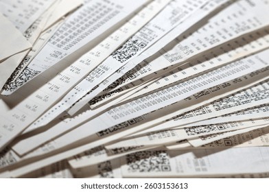 Stack of store receipts and bills on table, concept of rising inflation, cost of living crisis and family budget management