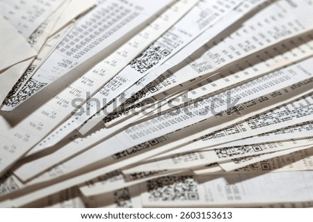 Stack of store receipts and bills on table, concept of rising inflation, cost of living crisis and family budget management