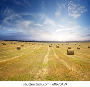 Stack of straw on the mown field beneath a blue sky, Tuscany