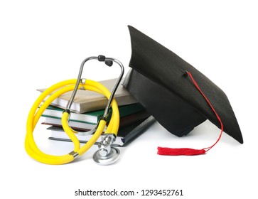 Stack Of Student Textbooks, Graduation Hat And Stethoscope On White Background. Medical Education