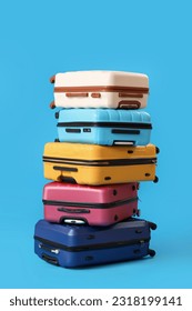 Stack of suitcases on blue background