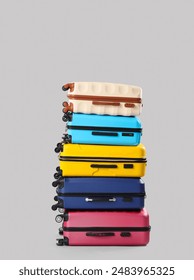Stack of suitcases on grey background. Travel concept