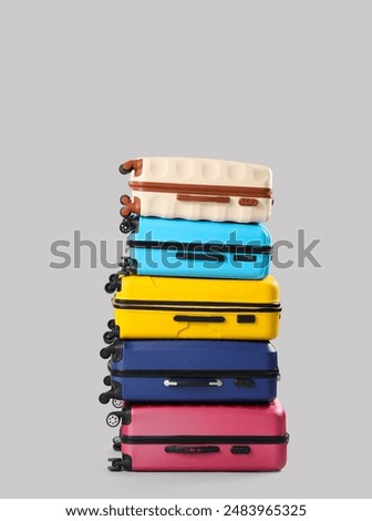 Stack of suitcases on grey background. Travel concept