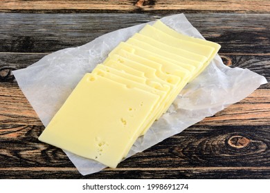 Stack Of Swiss Cheese Slices Cold Cuts On White Butcher Deli Paper