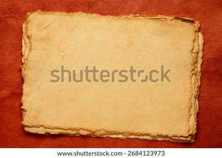 stack of tan toned heavyweight deckle edge paper sheets