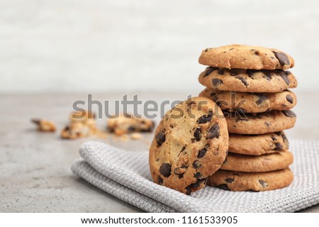 Stack of tasty chocolate cookies on gray table