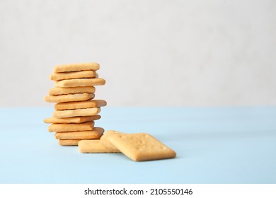 Stack of tasty crackers on table