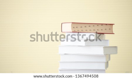 Stack of textbook on floor.Stack of white textbook and red textbook on top on table isolate on white background,Education, textbook, back to school concept. Copy space