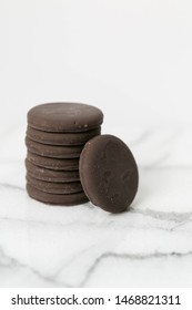 Stack Of Thin Mints Cookies On White Marble Background, Chocolate Mint Thin Round Cookies