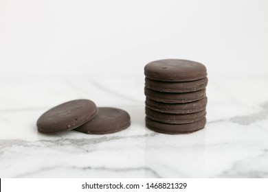 Stack Of Thin Mints Cookies On White Marble Background, Chocolate Mint Thin Round Cookies