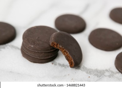 Stack Of Thin Mints Cookies On White Marble Background, Chocolate Mint Thin Round Cookies
