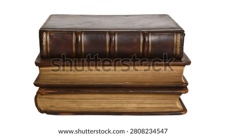 Stack of three antique leather bound books with gold leaf detailing