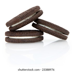 Stack Of Three Chocolate Cream Oreo Cookies Over White.