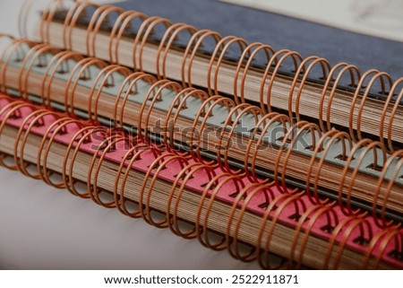 Stack of three colourful craft paper spiral binding photo albums in blue, green, and magenta. Ideal for DIY scrapbooking, memory keeping, and creative photo displays in vibrant styles.