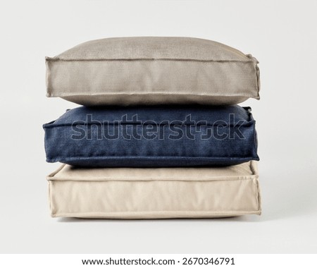 Stack of three cushions forming a relaxing pile on white background