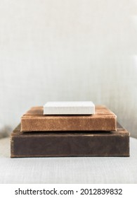 Stack Of Three Leather Photo Books On Cream Linen Background