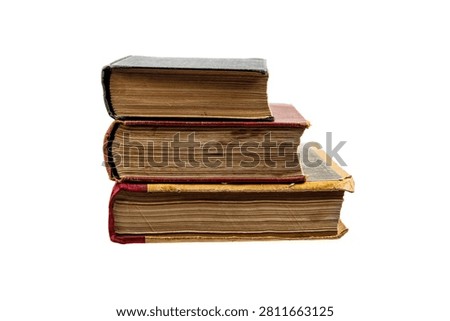 Stack of three old weathered vintage books isolated on a white background.
