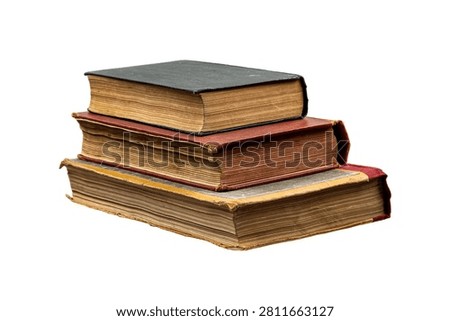Stack of three old weathered vintage books isolated on a white background.