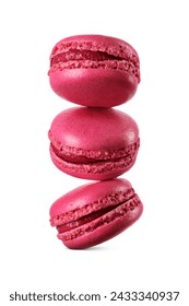 A stack of three vivid red macarons levitated in mid-air isolated on a white background. Sweet French sandwich cookies.
