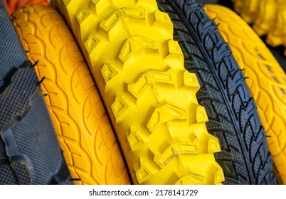 Stack Of Tires For For Agriculture Machines,for Sale.yellow,orange And Black Colors Tires.outside Market,shop,synthetic Rubber.fat Bike Tire.wheelbarrow Solid Wheel.gardening,farming Concept