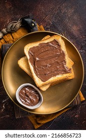 Stack Of Toasts With Chocolate Hazelnut Cream In Plate. Dark Background. Top View.