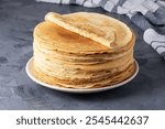 Stack of traditional russian pancakes blini on gray background. Homemade russian thin pancakes blini. Russian food, russian kitchen