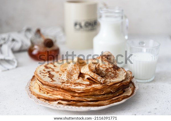 Stack\
of traditional russian pancakes blini on wooden background.\
Maslenitsa traditional Russian festival\
meal.	\
