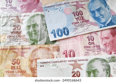 Stack of Turkish lira (TRY) banknotes as background.