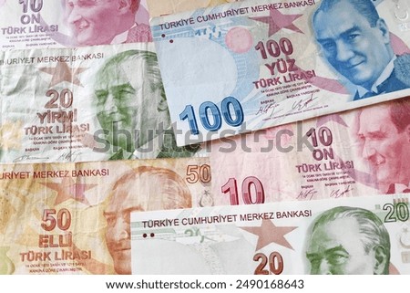 Stack of Turkish lira (TRY) banknotes as background.