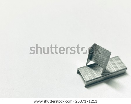 Stack of two staples on the white bachground