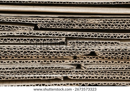 A stack of unfolded cardboard packing boxes in a close-up. Background.