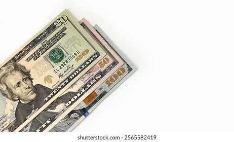 Stack of United States currency notes in denominations of 20 dollar bill, 50 dollar bill, 100 dollar bill, placed diagonally on a white background. Minimalistic composition suitable for financial, bus