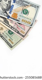 Stack of US dollar bills in 20, 50, and 100 denominations, arranged diagonally on a clean white background. Ideal for advertising financial services, investment opportunities, or wealth management con