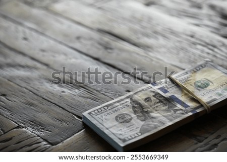 Stack of US Dollar Bills on Wooden Table, Close-up of Hundred Dollar Notes, Financial and Economic Concept