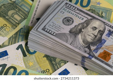 Stack Of US Dollars On Top Of Euro Banknotes Background
