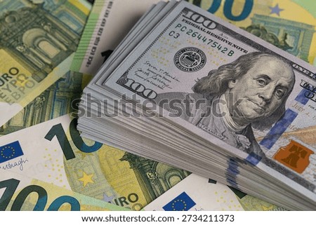 Stack Of US Dollars On Top Of Euro Banknotes Background