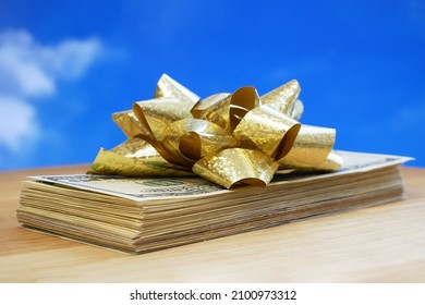 stack of usa dollars and bow, Money gift, pile of cash with golden bow, closeup